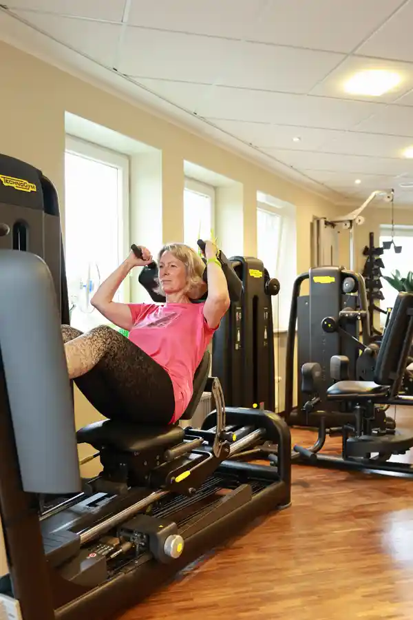 Core-Training am Biocircuit-Gerät Frau macht Bauchmuskeltraining mit geführter Bewegung an ergonomischem Gerät im Biocircuit.