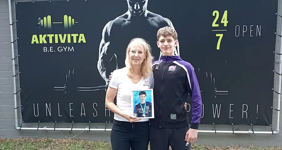 Marita Lorenz-Ruthenberg und Schwimmer Phelan Topp vor dem AKTIVITA B.E. GYM in Bad Essen
